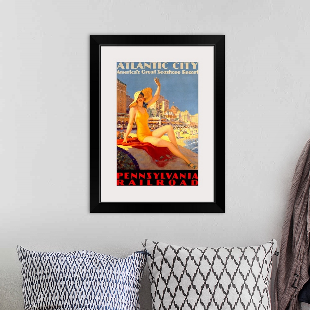 A bohemian room featuring Antique poster advertising beach resort.  A woman in a swimsuit and hat sits on a rock waving wit...