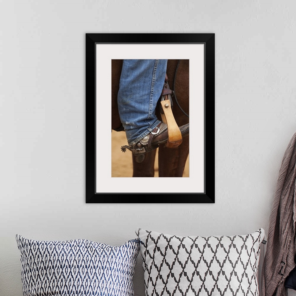 A bohemian room featuring Cowboy boot in horse stirrup with spurs