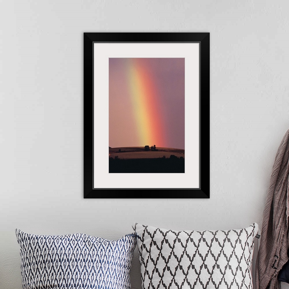 A bohemian room featuring Rainbow in a sunset sky