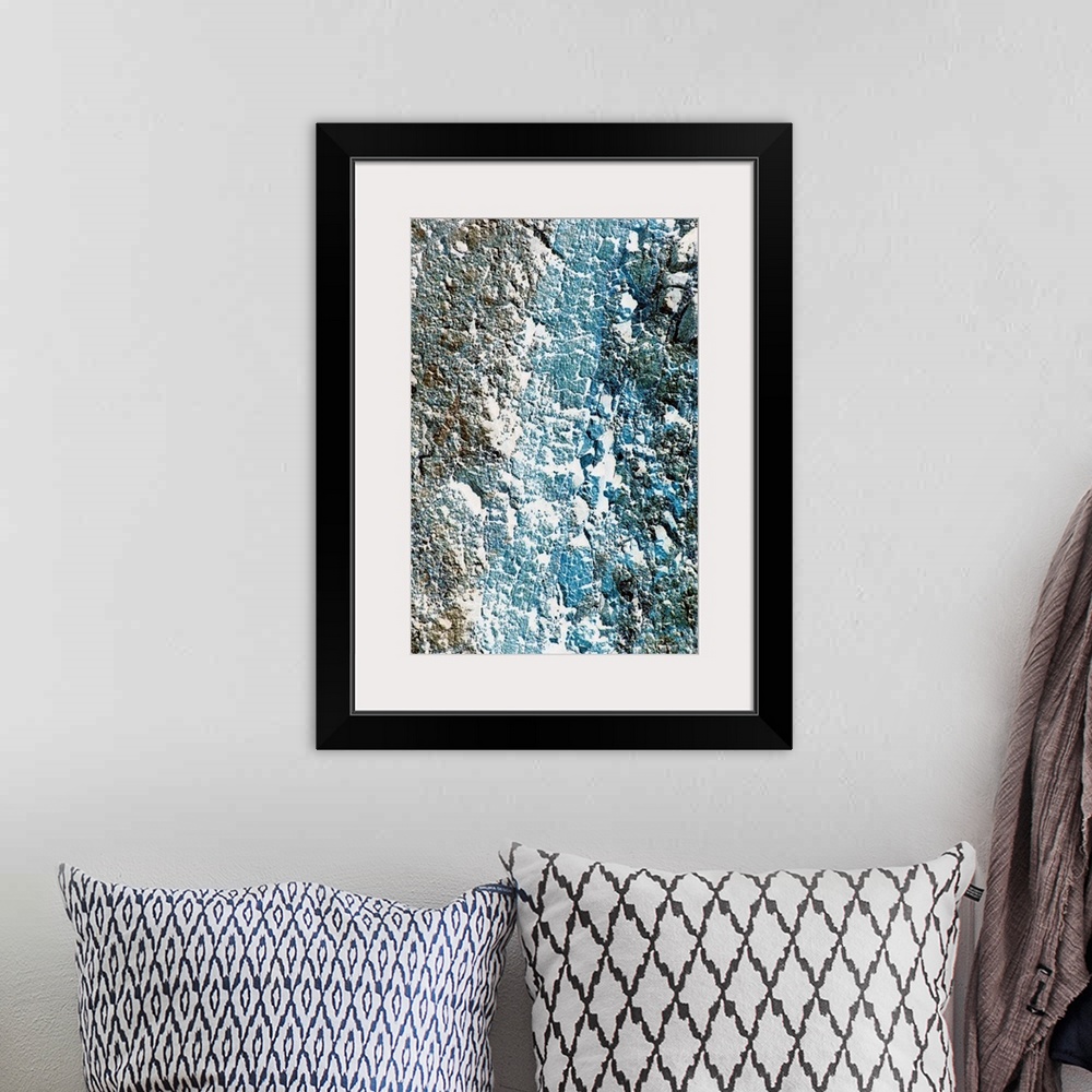 A bohemian room featuring Tall printed canvas of the up close of a rock wall.