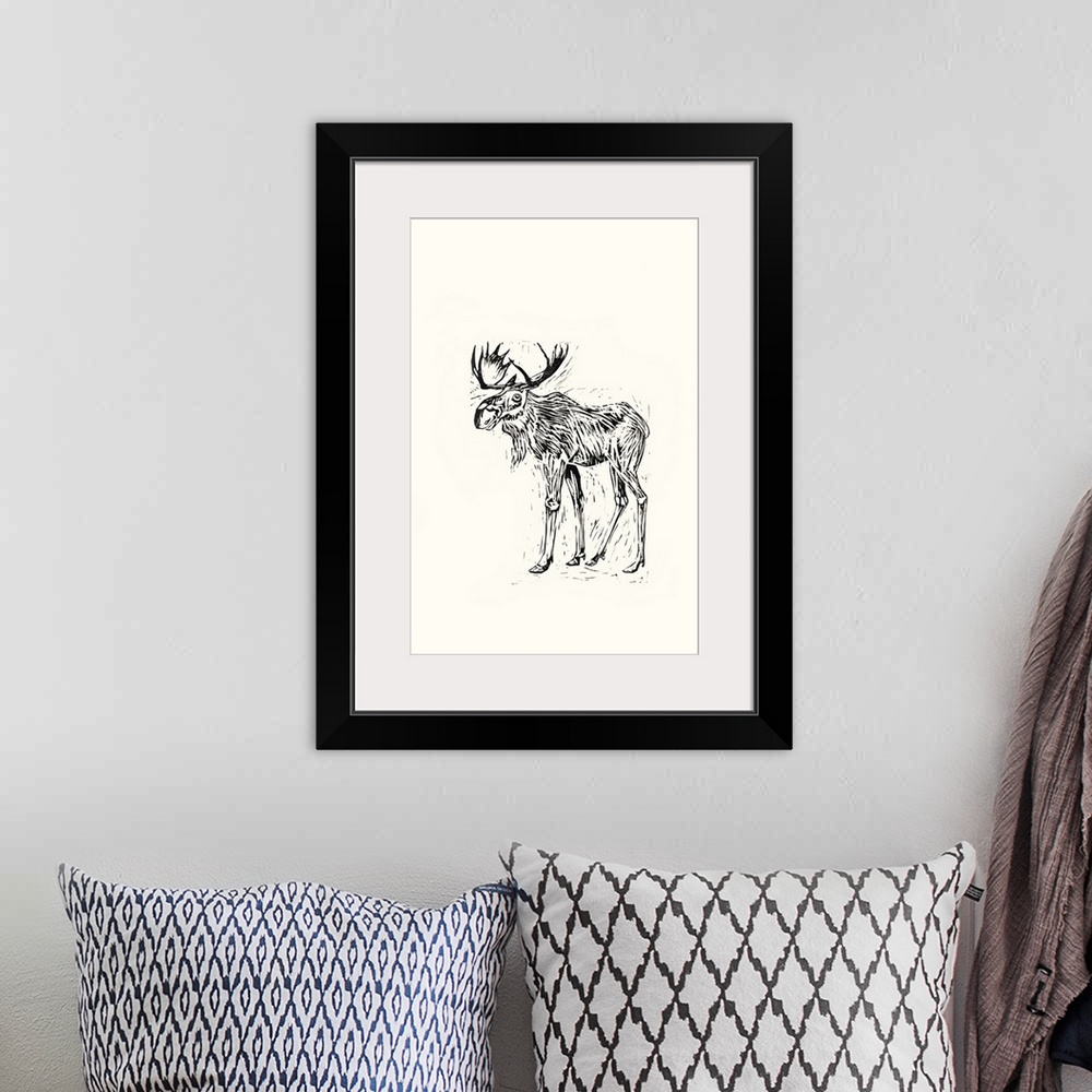 A bohemian room featuring Black and white block print illustration of a moose on an off white background.