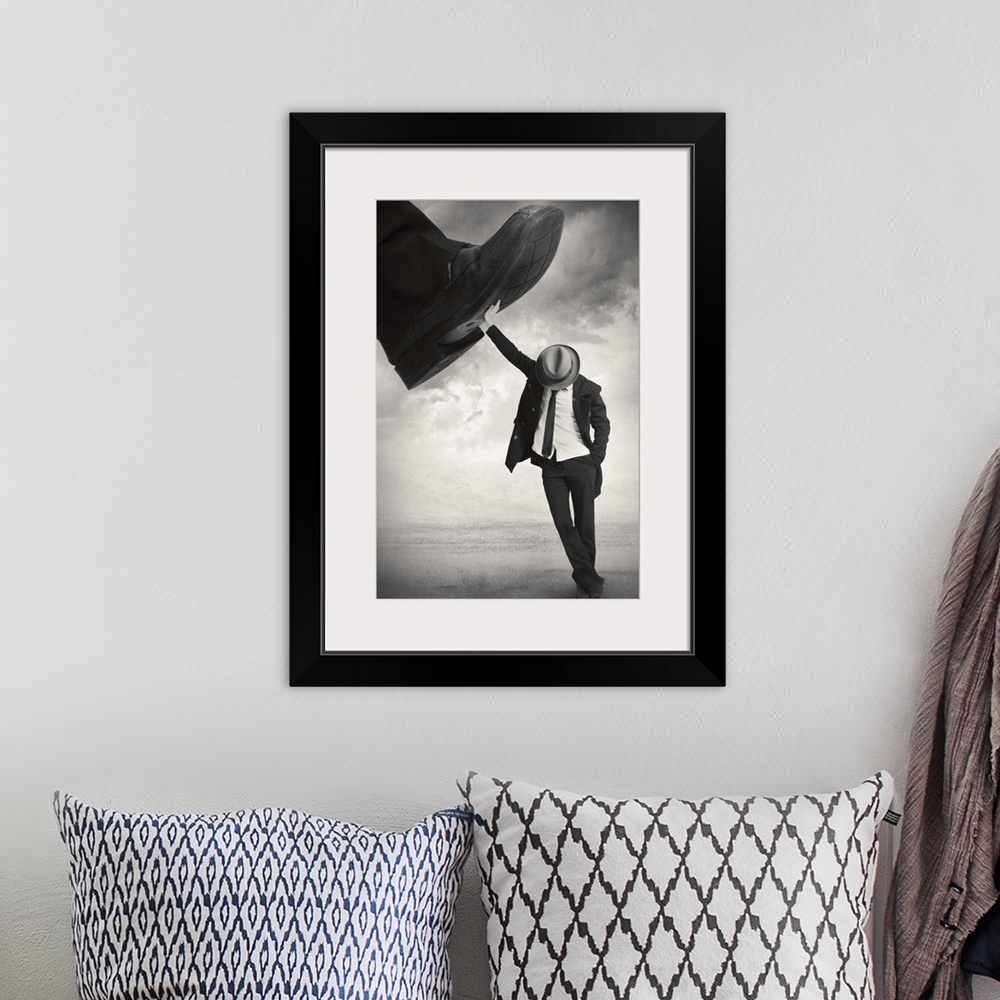 A bohemian room featuring An abstract art photograph of a man wearing a hat and suit, leaning against a giant foot trying t...