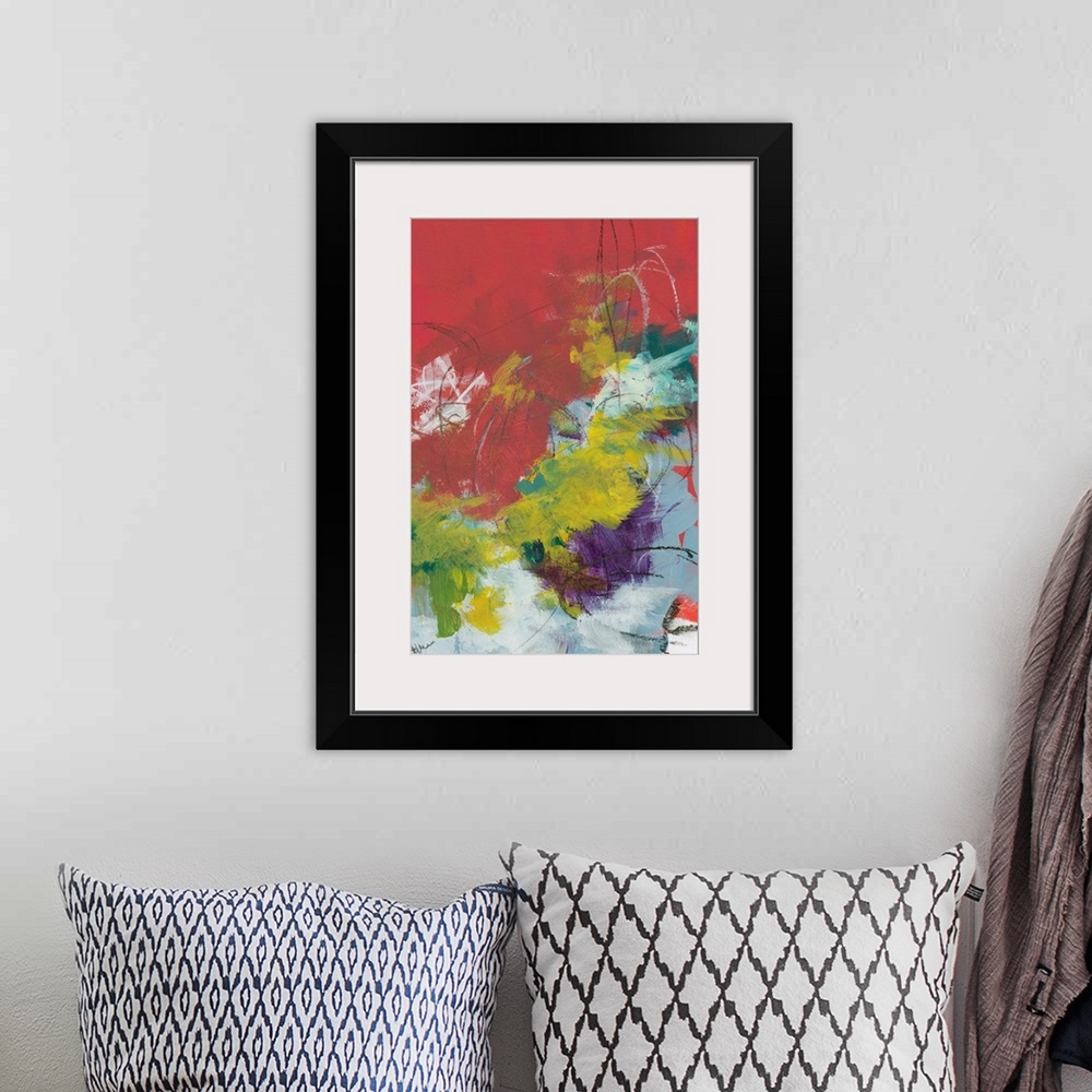A bohemian room featuring Abstract contemporary artwork of quick brushstrokes in yellow, red, and purple.