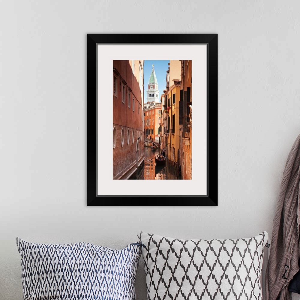 A bohemian room featuring Campanile and gondola on canal in Venice, Italy