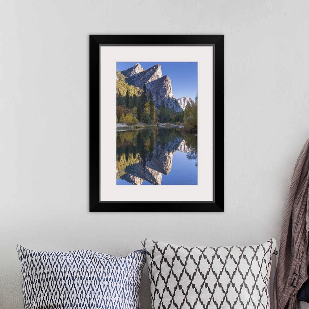 A bohemian room featuring The Three Brothers reflected in the Merced River at dawn, Yosemite Valley, California, USA. Autum...