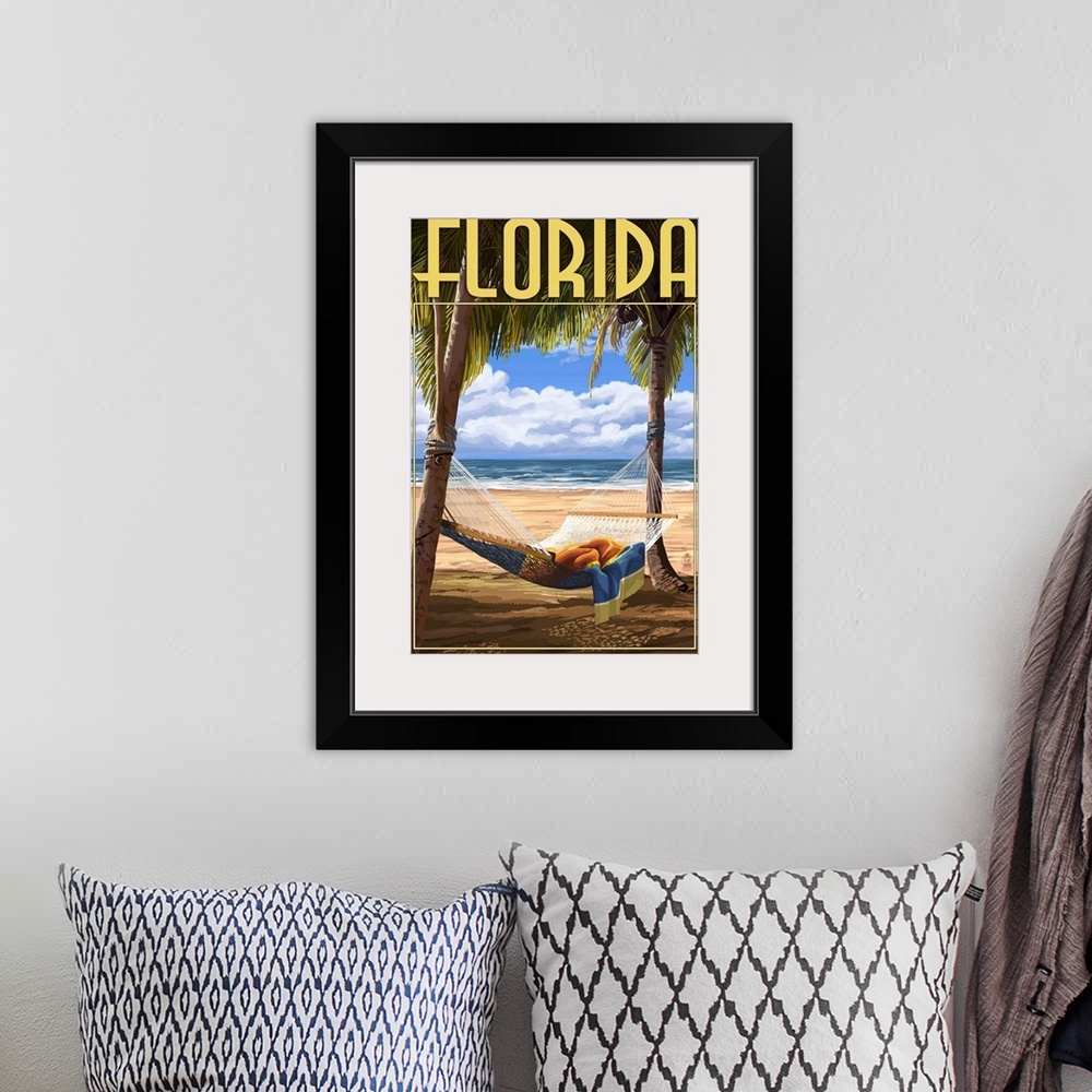 A bohemian room featuring Retro stylized art poster of a hammock tied up between two palm trees on a beach.