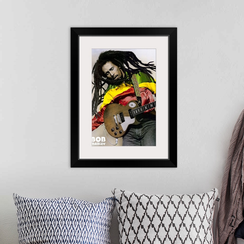 A bohemian room featuring Large, portrait photograph of Bob Marley playing guitar, his name in the bottom left corner.