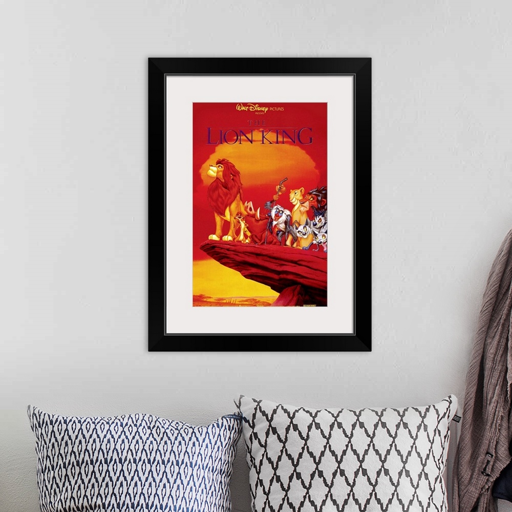 A bohemian room featuring Large, vertical movie advertisement of the Walt Disney movie, The Lion King.  A grown Simba peers...