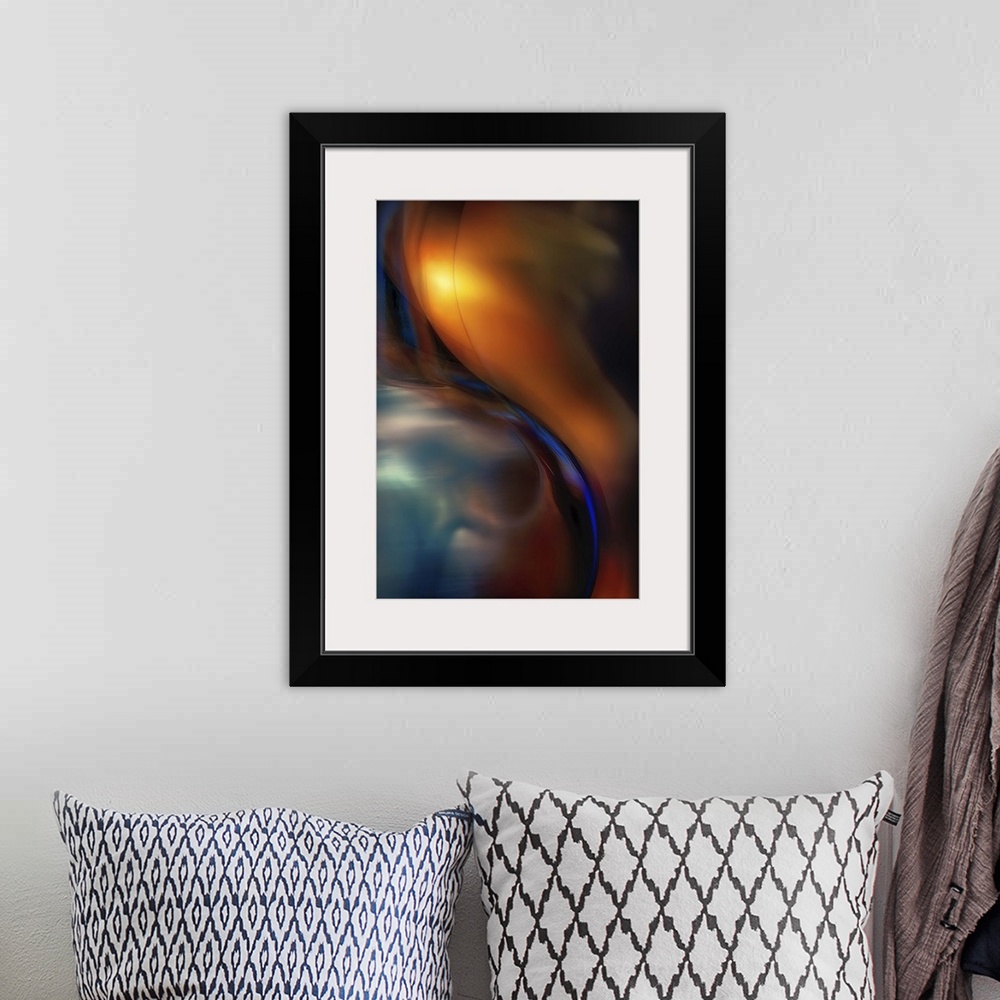 A bohemian room featuring Abstract photograph of curved blue glass against orange.