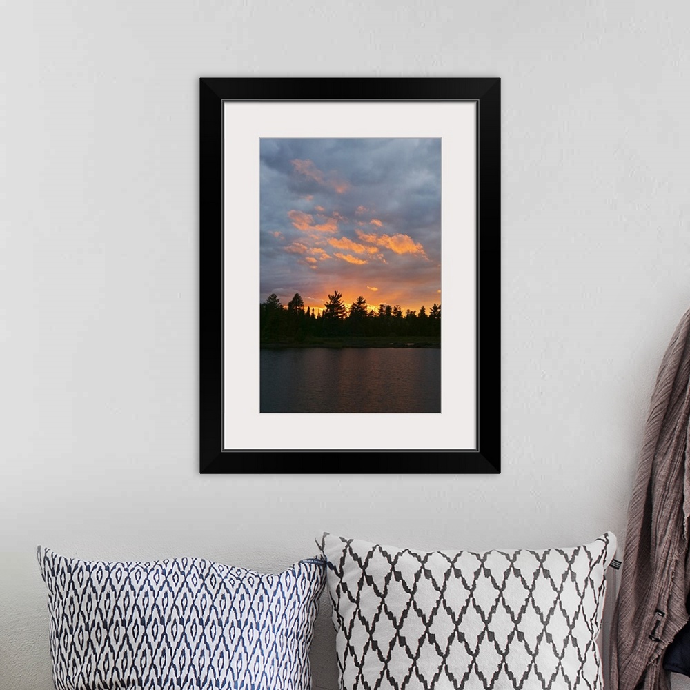 A bohemian room featuring Sunset behind silhouetted forest, Lake Three, Boundary Waters Canoe Area Wilderness, Minnesota