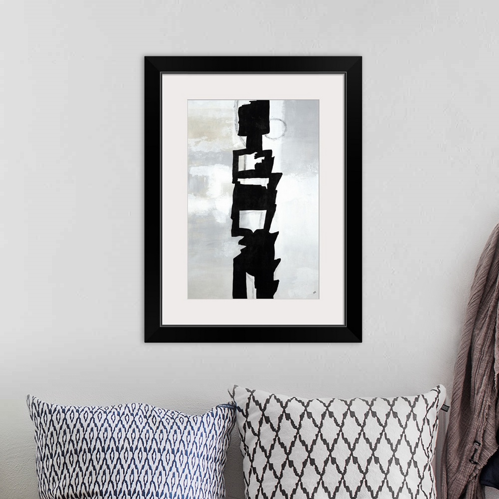 A bohemian room featuring Large vertical painting of a black abstract shape in the center of a gray background.