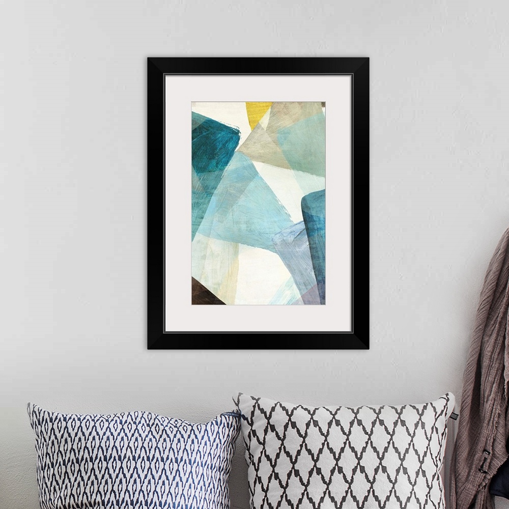 A bohemian room featuring Abstract artwork of overlapping shapes in blue and yellow tones.