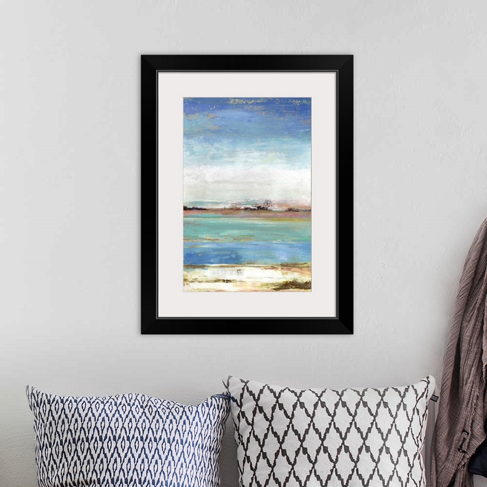 A bohemian room featuring Vertical artwork of an abstract landscape about a waterfront with blue skies.