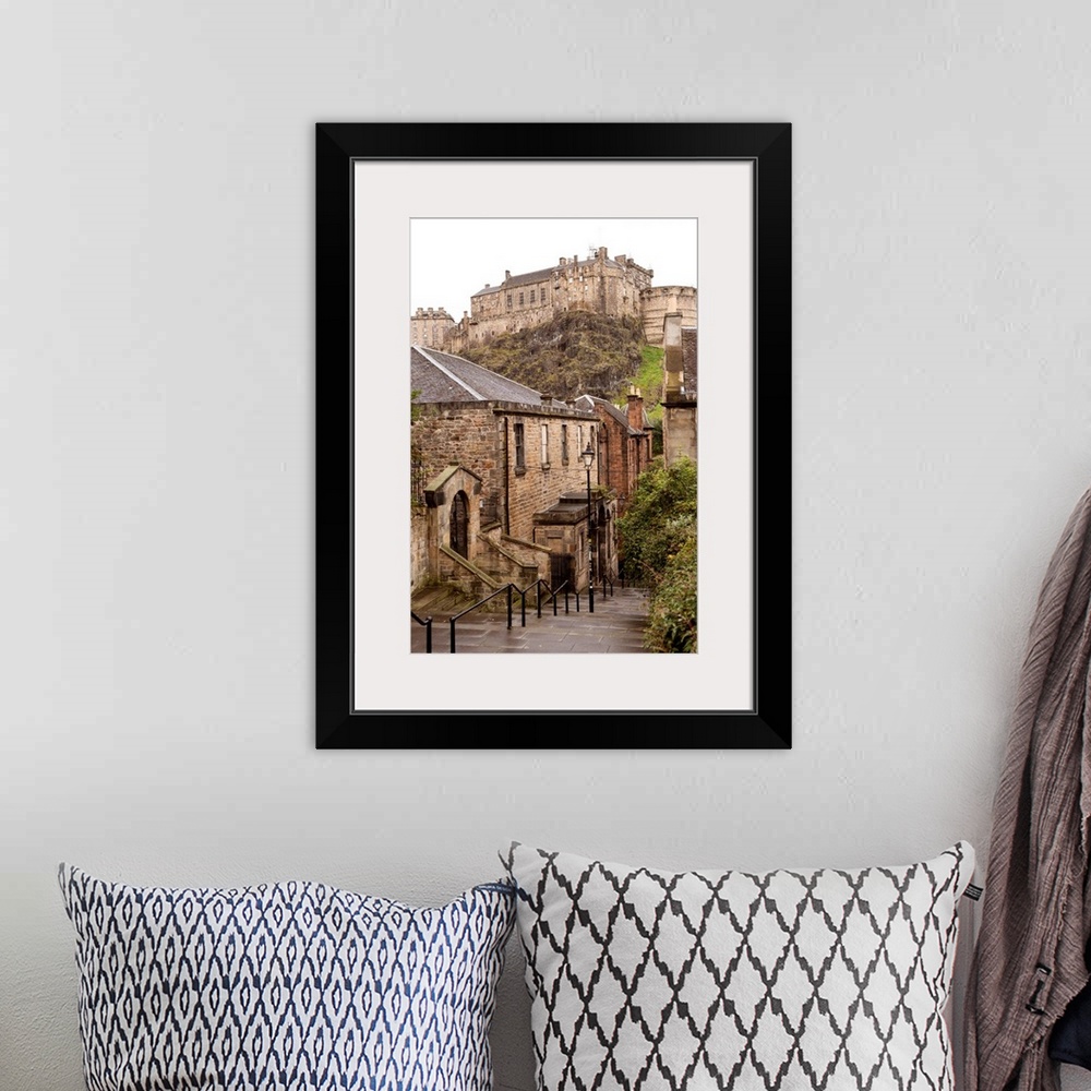 A bohemian room featuring Photograph of Edinburgh Castle with cobblestone buildings in the foreground.