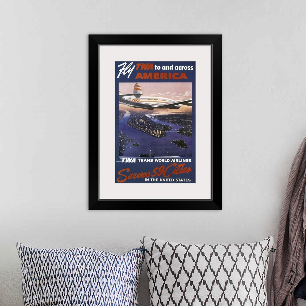 A bohemian room featuring A 1950s Trans-World Airlines poster showing a TWA Lockheed Constellation over Manhattan.