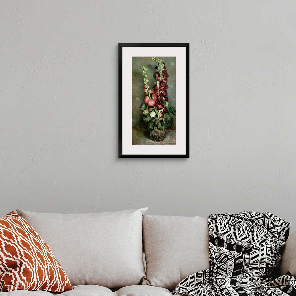A bohemian room featuring Classic vertical floral art of a tall vase of Hollyhock flowers in bloom.