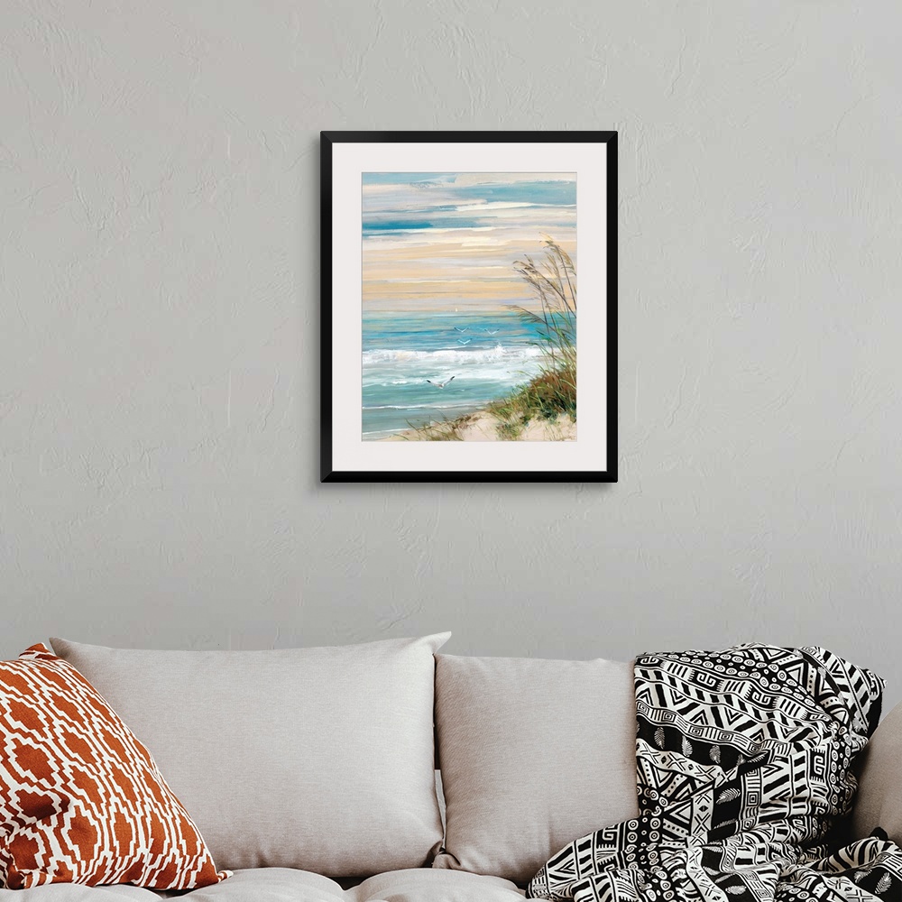 A bohemian room featuring Contemporary painting of a beach scene with crashing ocean waves, beach grass blowing in the wind...