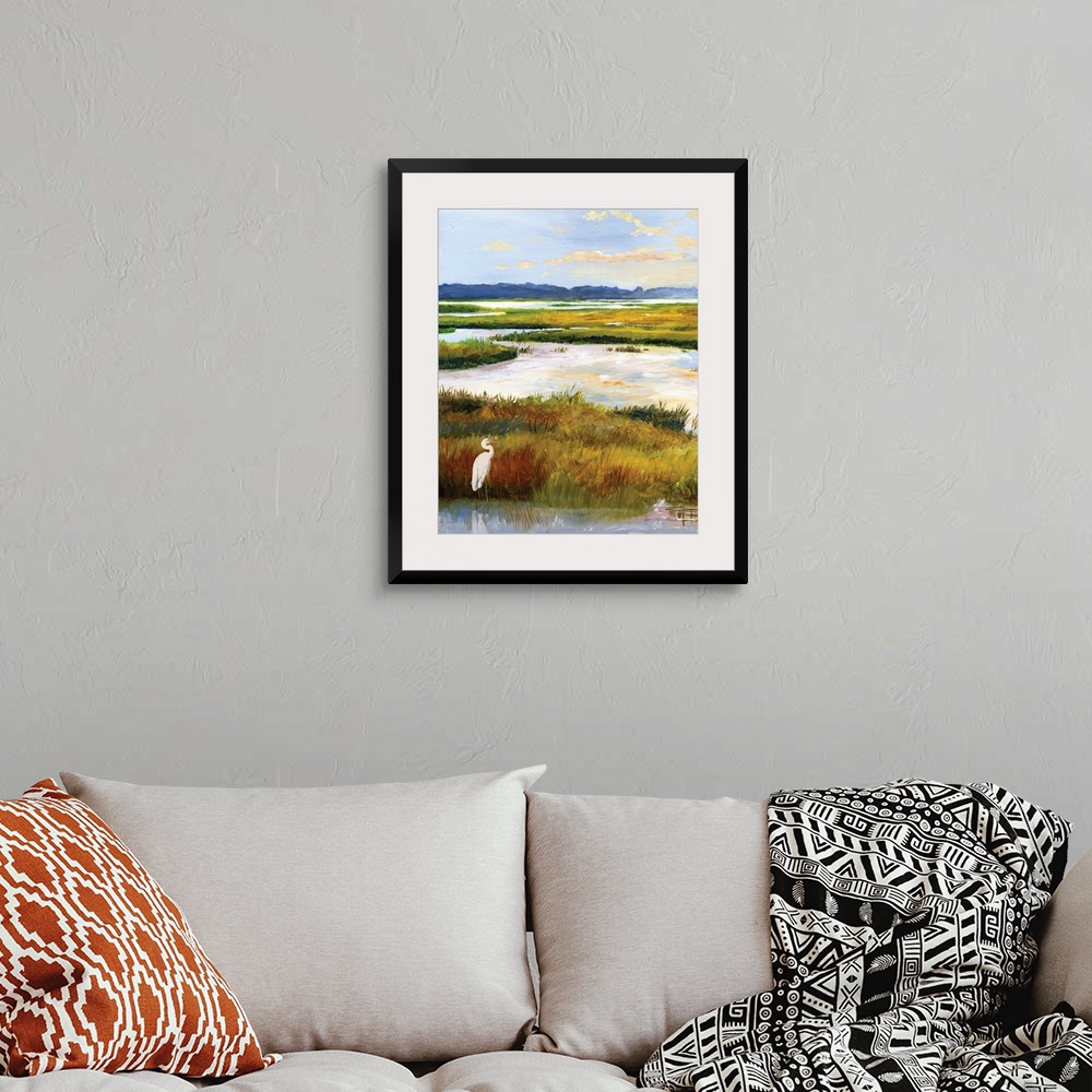 A bohemian room featuring A serene scene of water and grasses illuminated by the late afternoon sun. A white heron stands p...