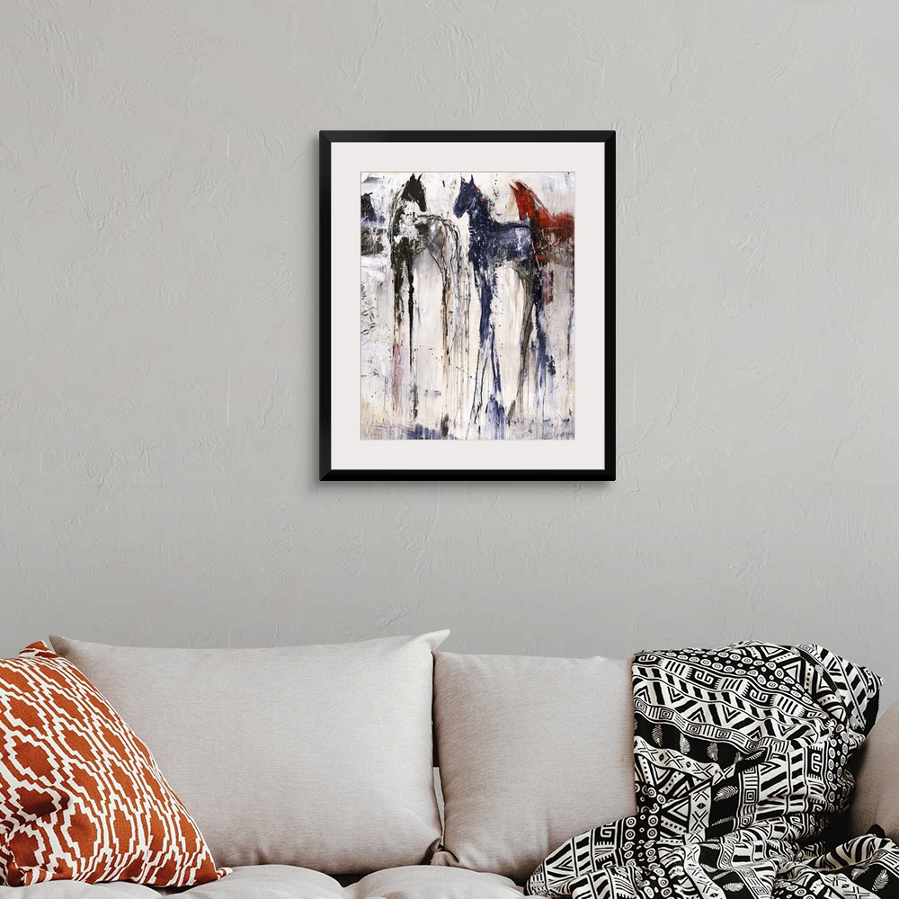 A bohemian room featuring Tall abstract painting of three horses with vertical lines of color.