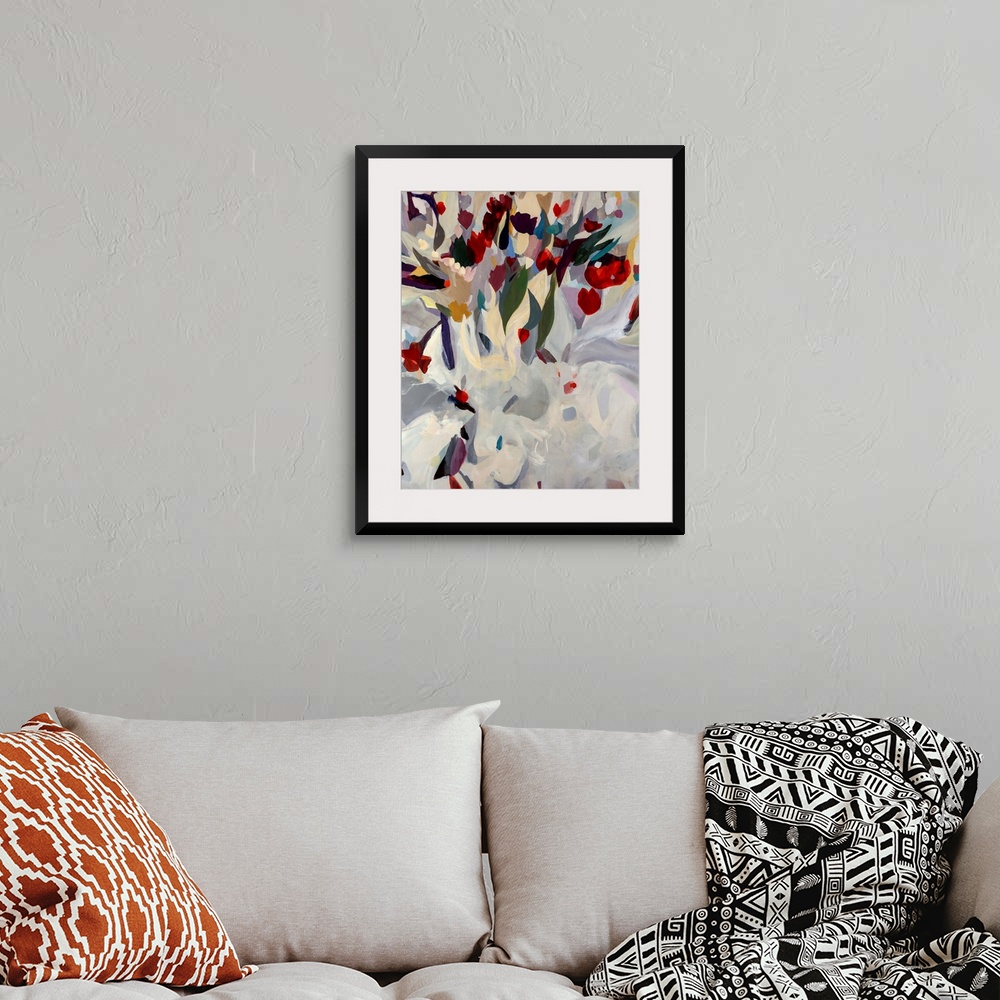 A bohemian room featuring Large abstract modern painting of a uniquely arranged bouquet of blooming flowers. Vibrant tones ...