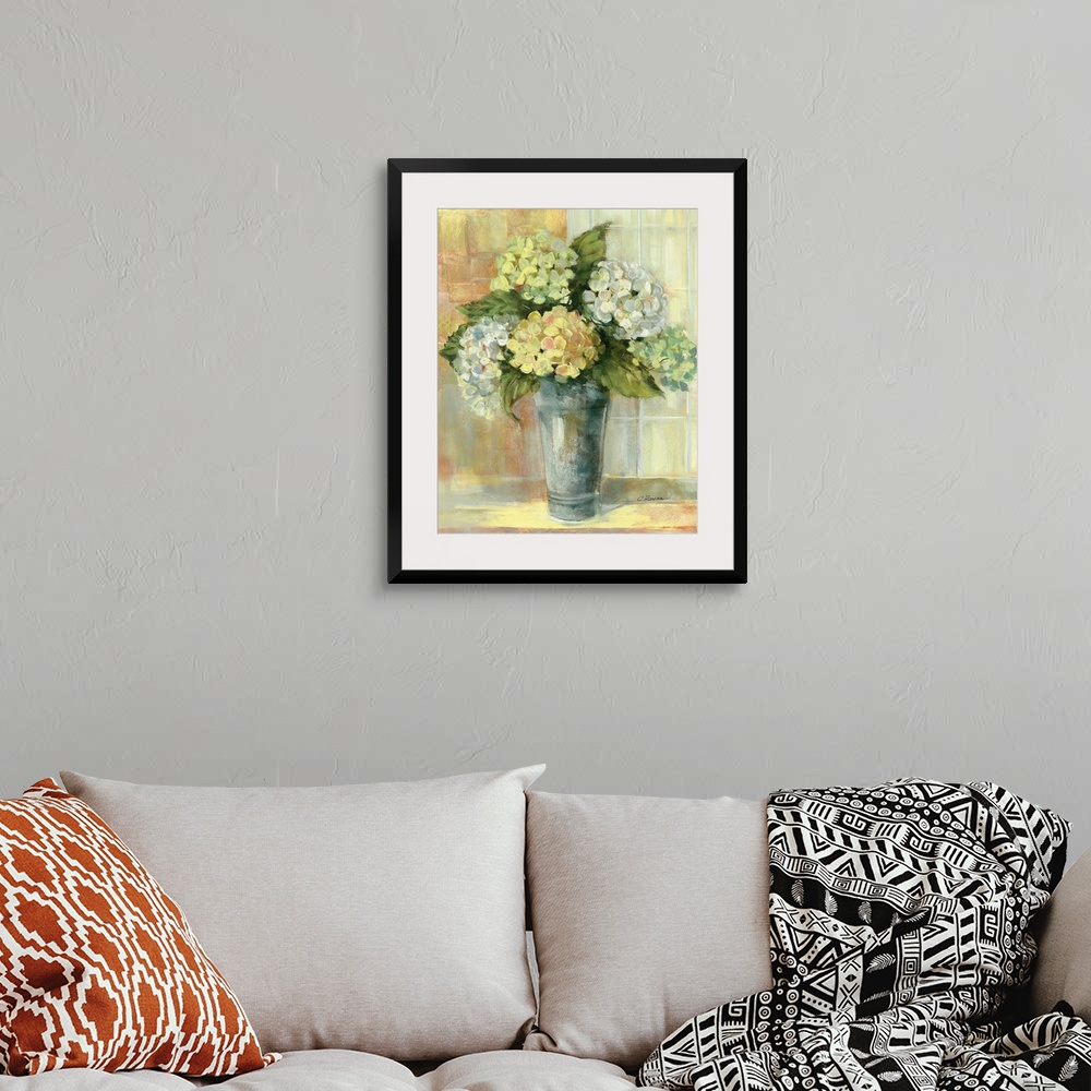 A bohemian room featuring Portrait, large still life painting of golden hydrangeas in a vase, sitting on a counter if front...
