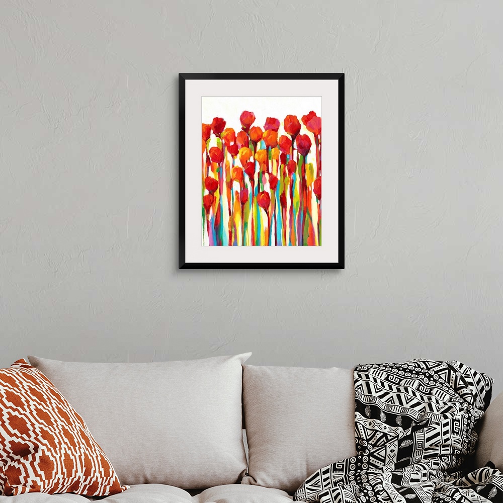 A bohemian room featuring Bright contemporary painting of red flowers with rainbow stems.