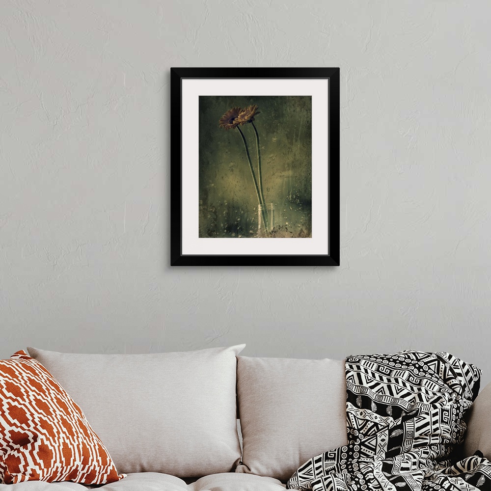 A bohemian room featuring Grungy photograph of long stem flowers in a small glass vase.