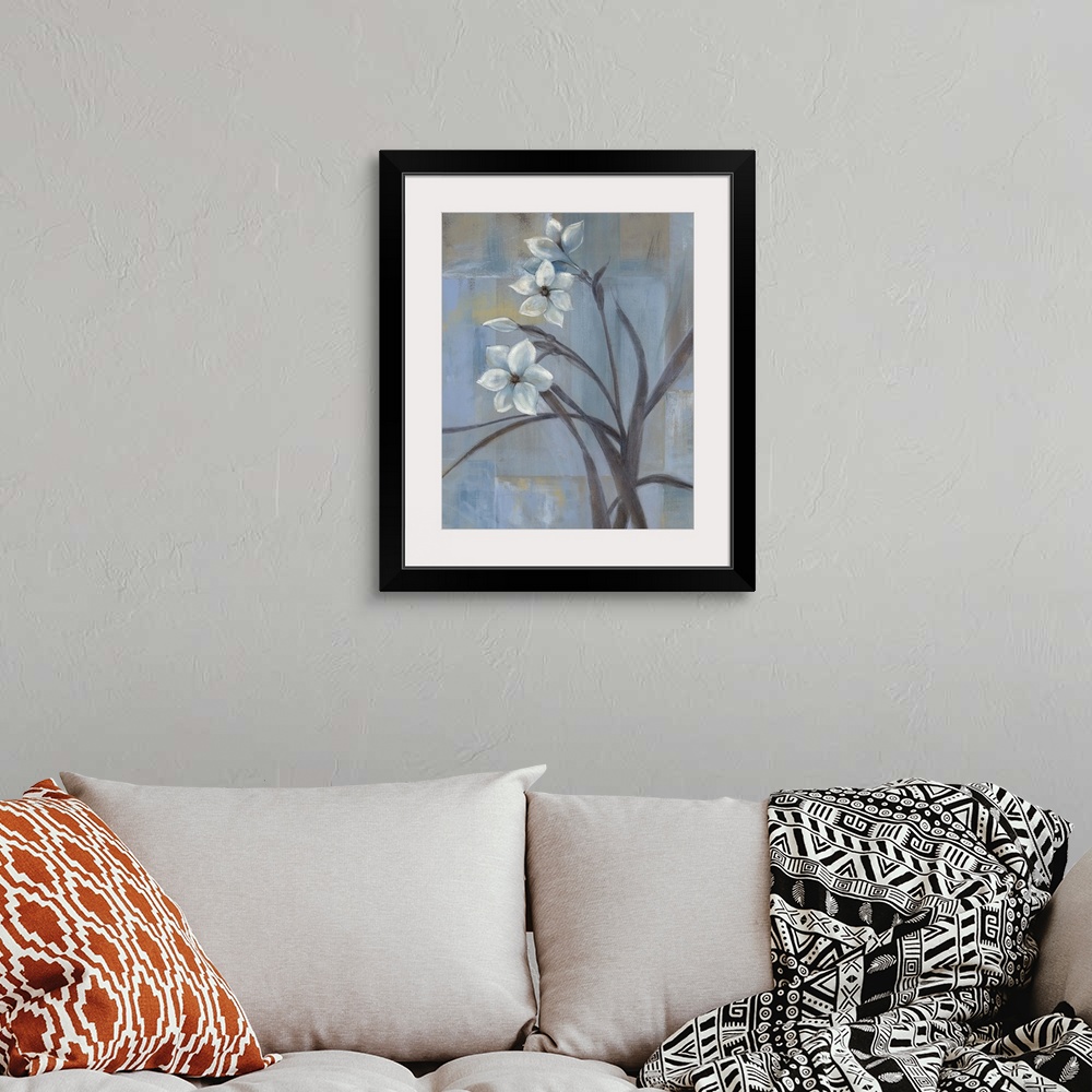A bohemian room featuring Contemporary painting of three white tulips and slender leaves and stems.