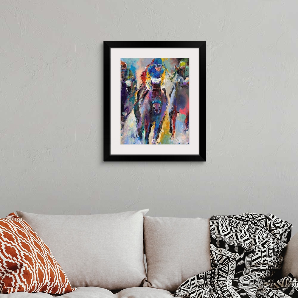 A bohemian room featuring Colorful abstract painting of jockeys on horseback.