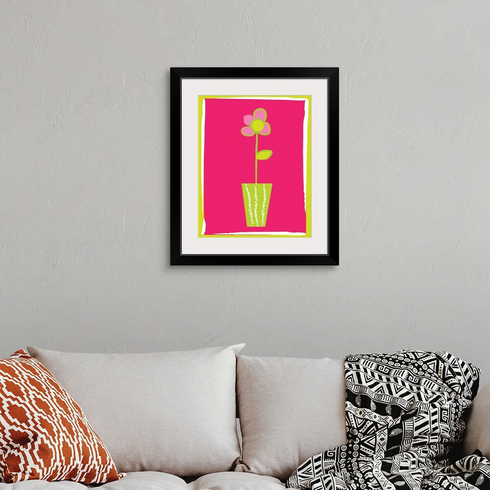 A bohemian room featuring pink flower in a vase