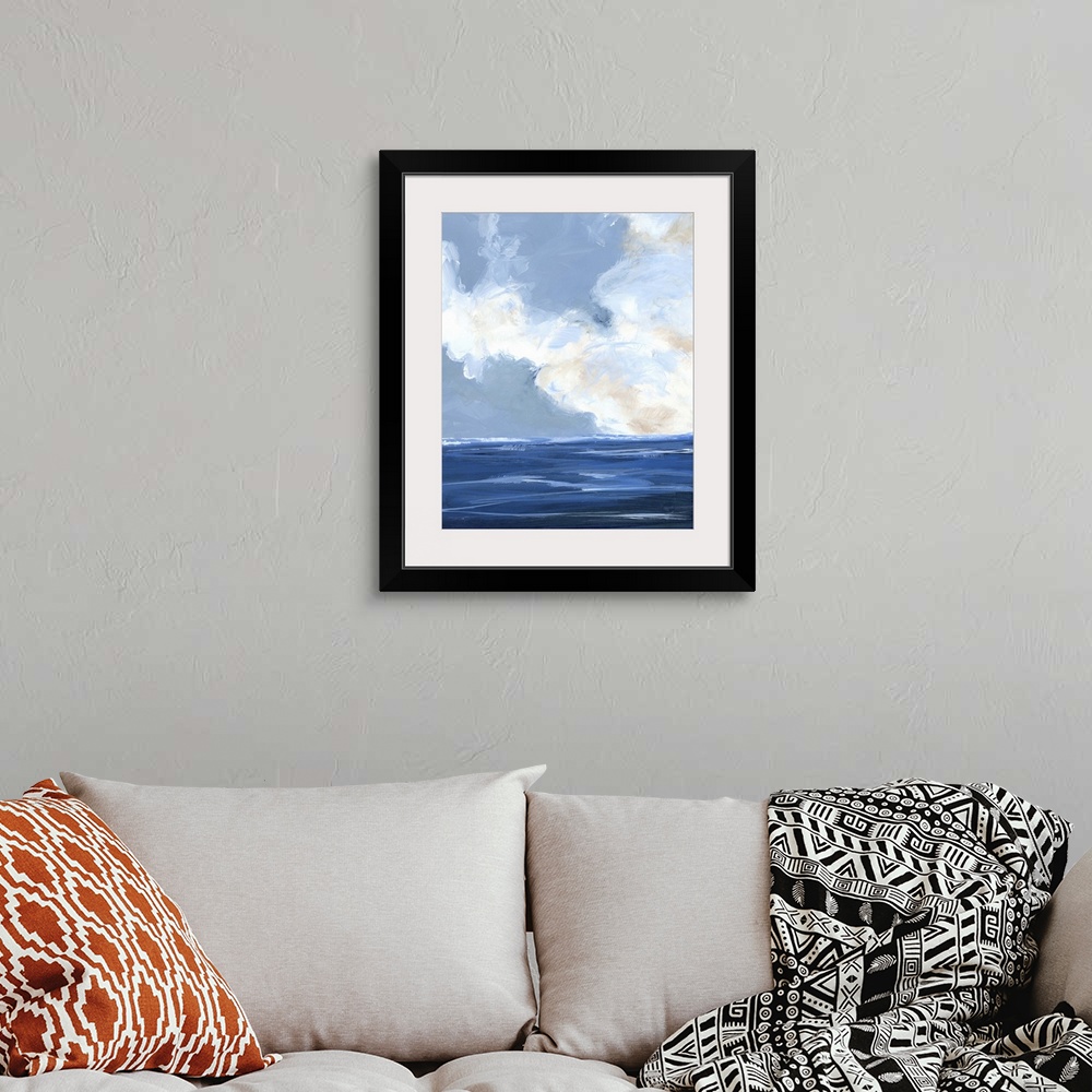 A bohemian room featuring Contemporary painting of a calm ocean with large white clouds on the horizon.