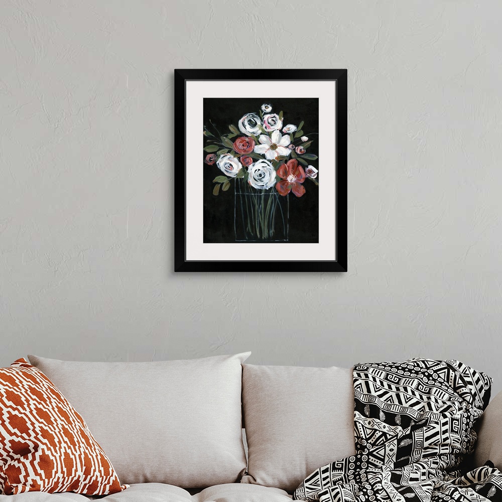 A bohemian room featuring Large vertical painting with white and red flowers in a glass vase on a solid black background cr...