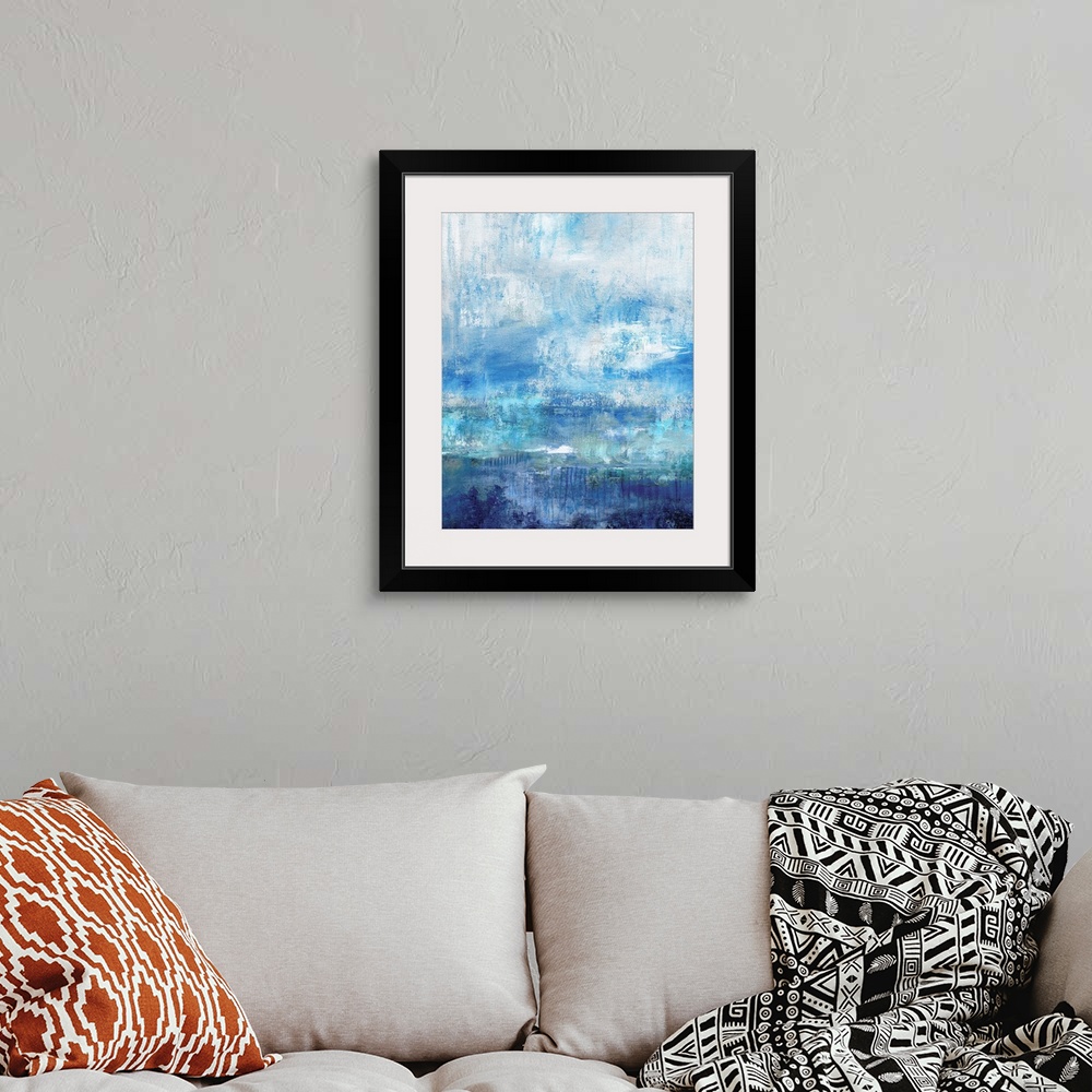 A bohemian room featuring Abstract painting with different shades of blue and a white overlay resembling mist.