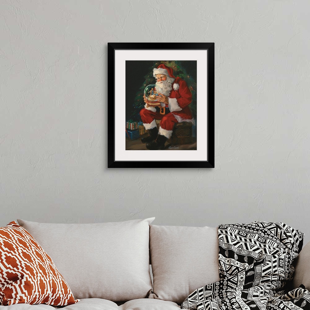 A bohemian room featuring Decor for the holiday season of Santa holding a large snow globe with a Nativity scene and baby J...