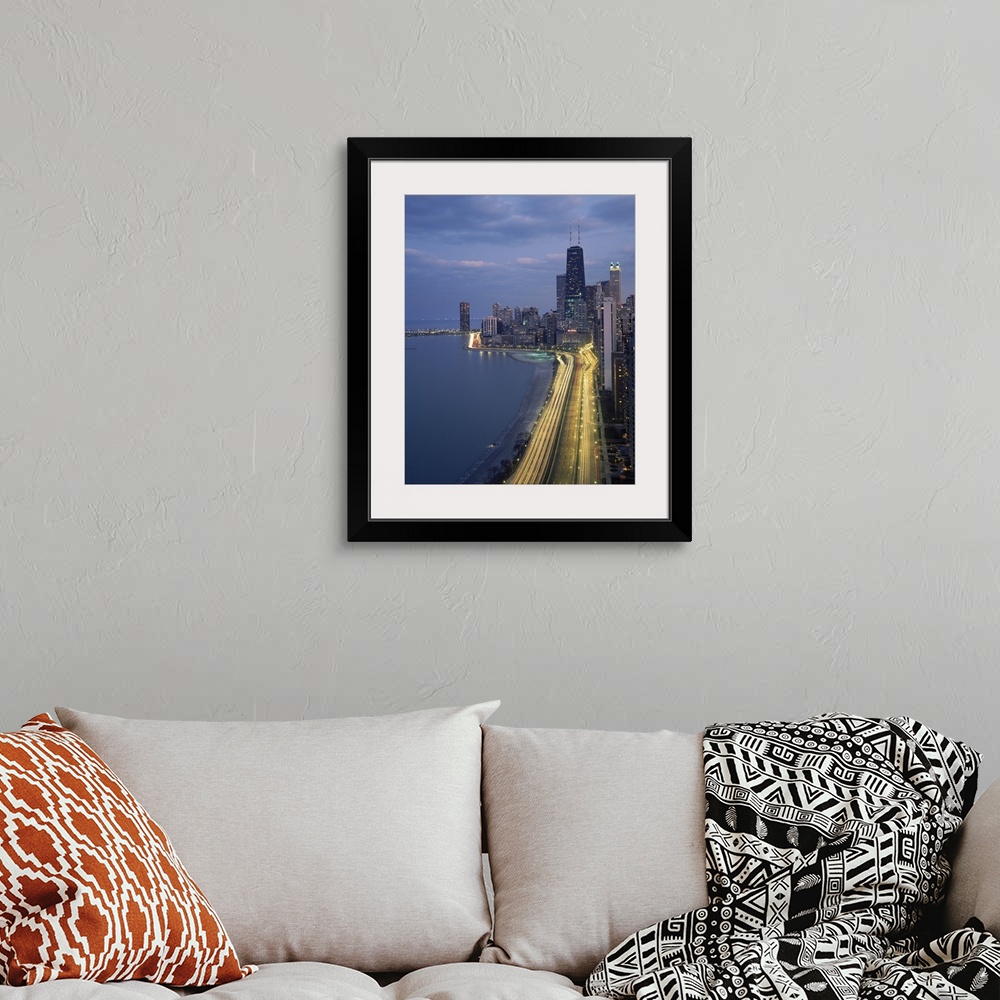 A bohemian room featuring Vertical panoramic photograph at dusk with city skyline in the distance and busy highway and stre...