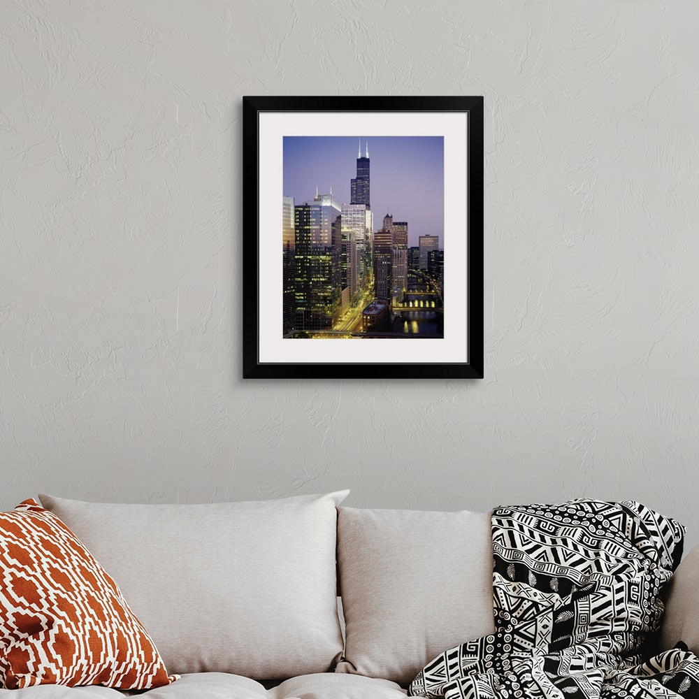 A bohemian room featuring Vertical photograph of several towering buildings in the urban city of Chicago at twilight.