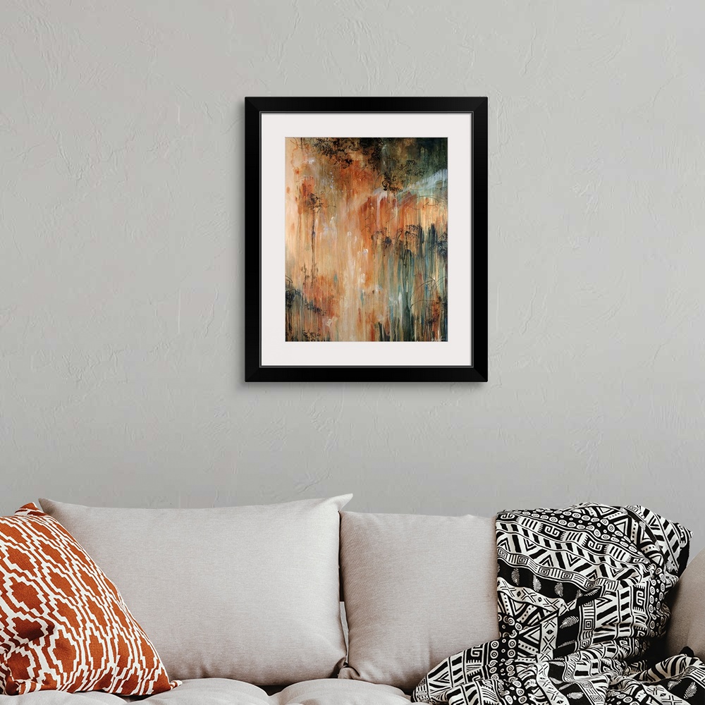 A bohemian room featuring Abstract painting of dark paint splashed and dripped on top of warm tones.
