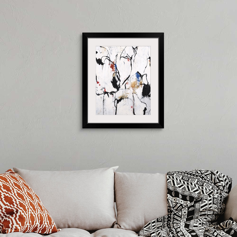 A bohemian room featuring Abstract artwork with bold, black lines and blotches of color on a white background with orange, ...