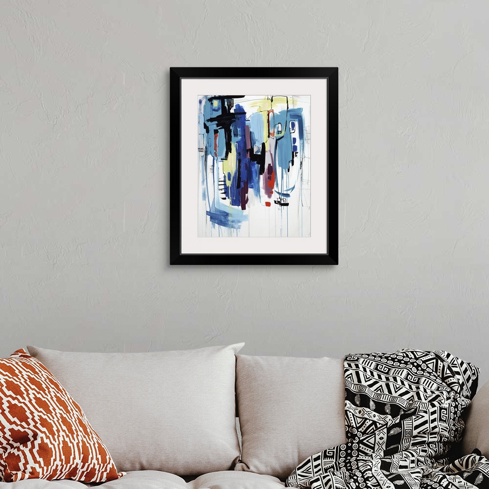 A bohemian room featuring Abstract painting of lines and blotches of various colors on a white canvas.
