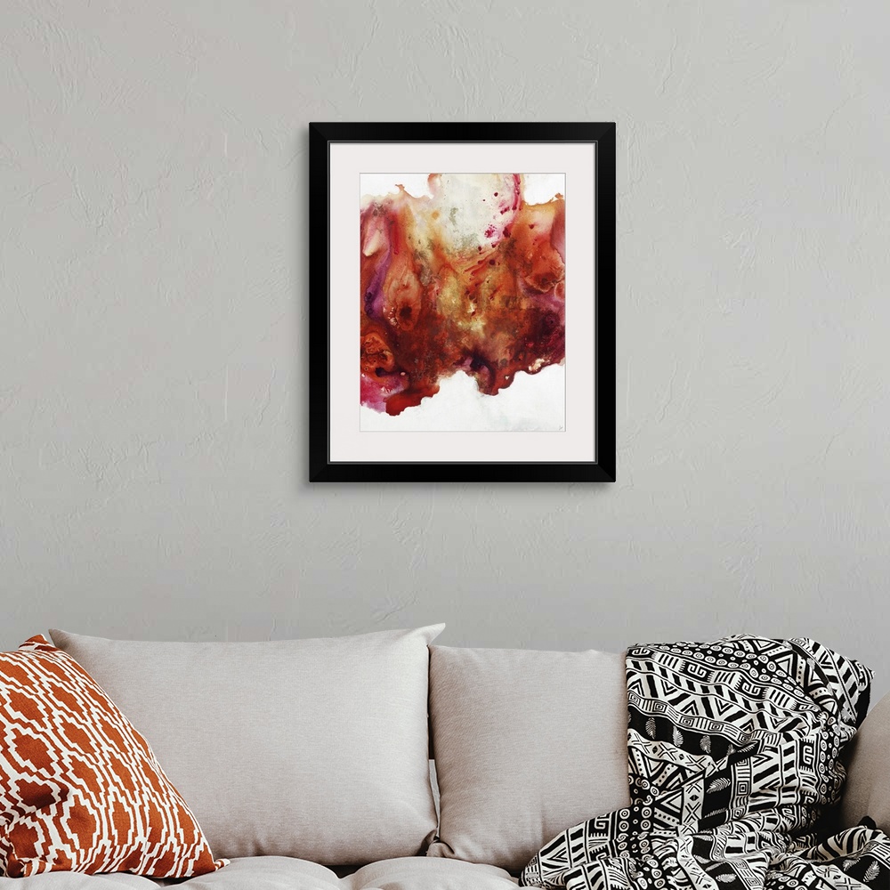 A bohemian room featuring Large abstract painting of vibrant colors of orange, red and pink.