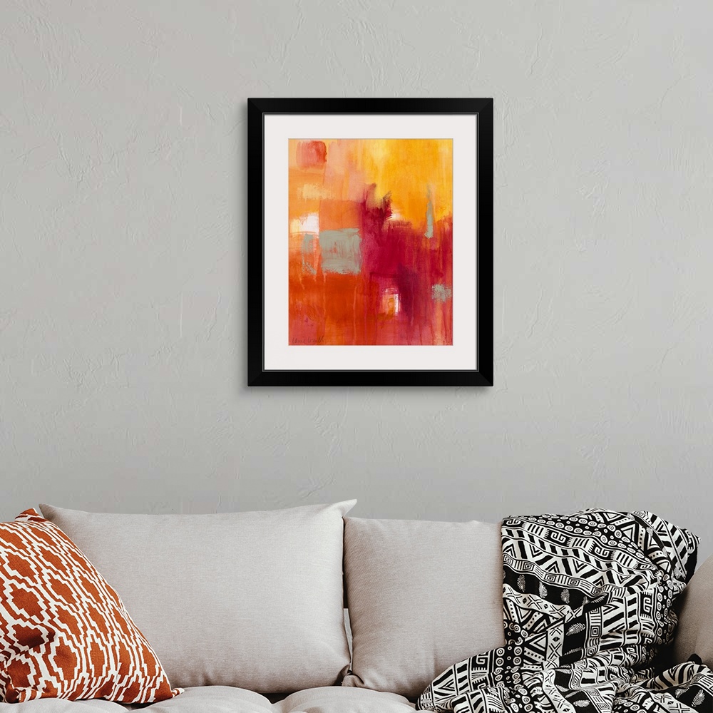 A bohemian room featuring Vertical, abstract painting on a big canvas of patches of transitioning colors in warm tones and ...