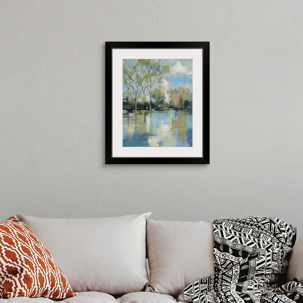 A bohemian room featuring A serene contemporary painting of trees behind a lake painted in a blocky abstract style