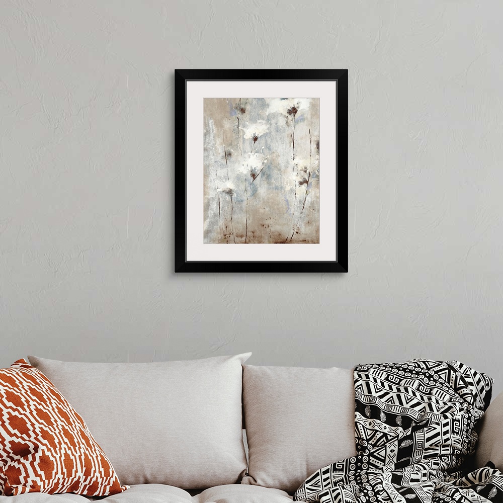 A bohemian room featuring A soft, contemporary painting of whispy white flowers on a neutral background with blue tones