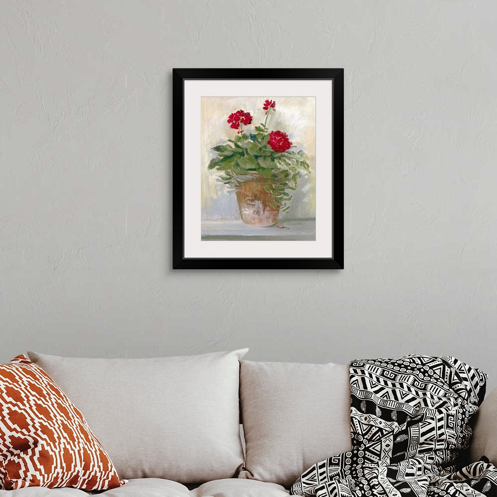 A bohemian room featuring Large painting on canvas of flowers planted in a pot sitting on the ground near a wall.