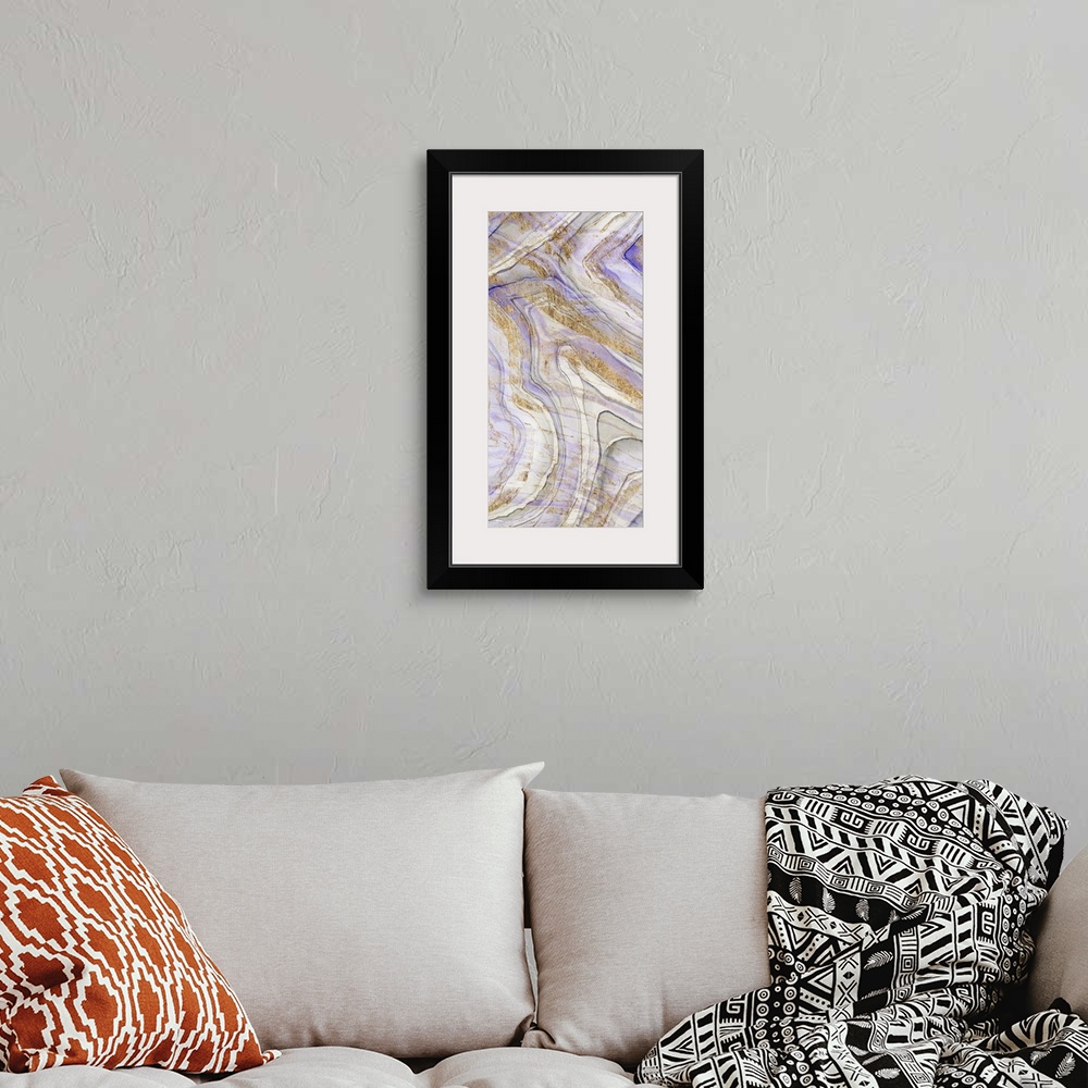 A bohemian room featuring Contemporary abstract artwork of layers of purple and gold, resembling sediments in stone.