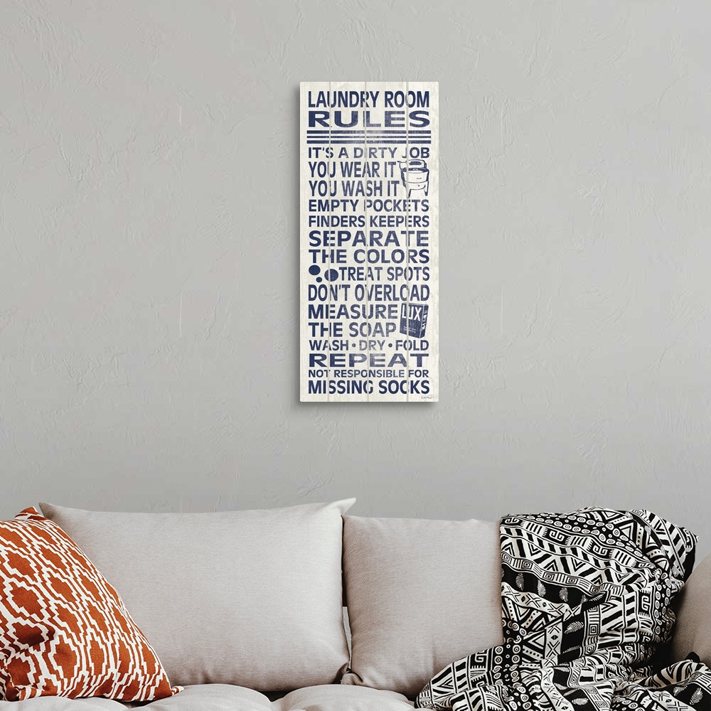 A bohemian room featuring Blue and white typography sign with a list of laundry room rules.