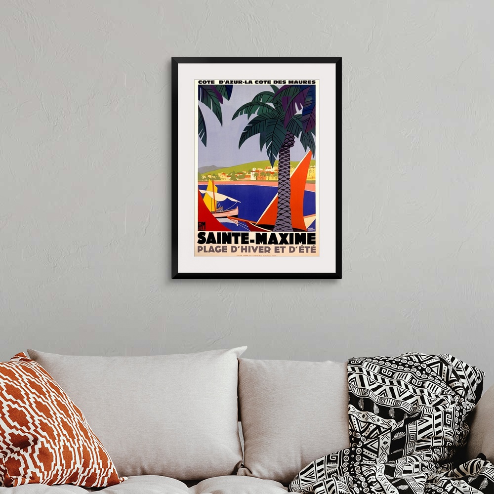 A bohemian room featuring Vertical, large vintage advertisement for Sainte-Maxime, France.  Palm trees over a body of water...