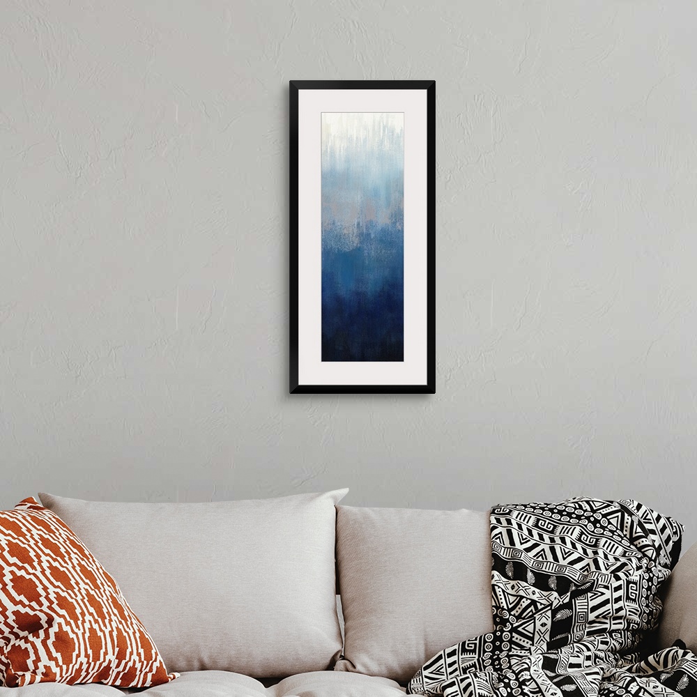 A bohemian room featuring Abstract panel painting in shades of gray and blue getting darker towards the bottom.