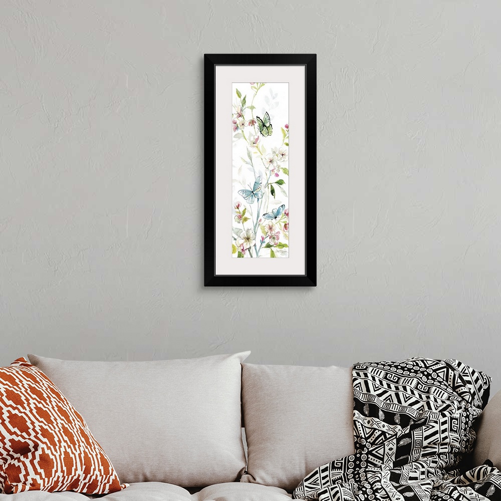 A bohemian room featuring A watercolor painting of three butterflies flying among branches covered in flowers and leaves.