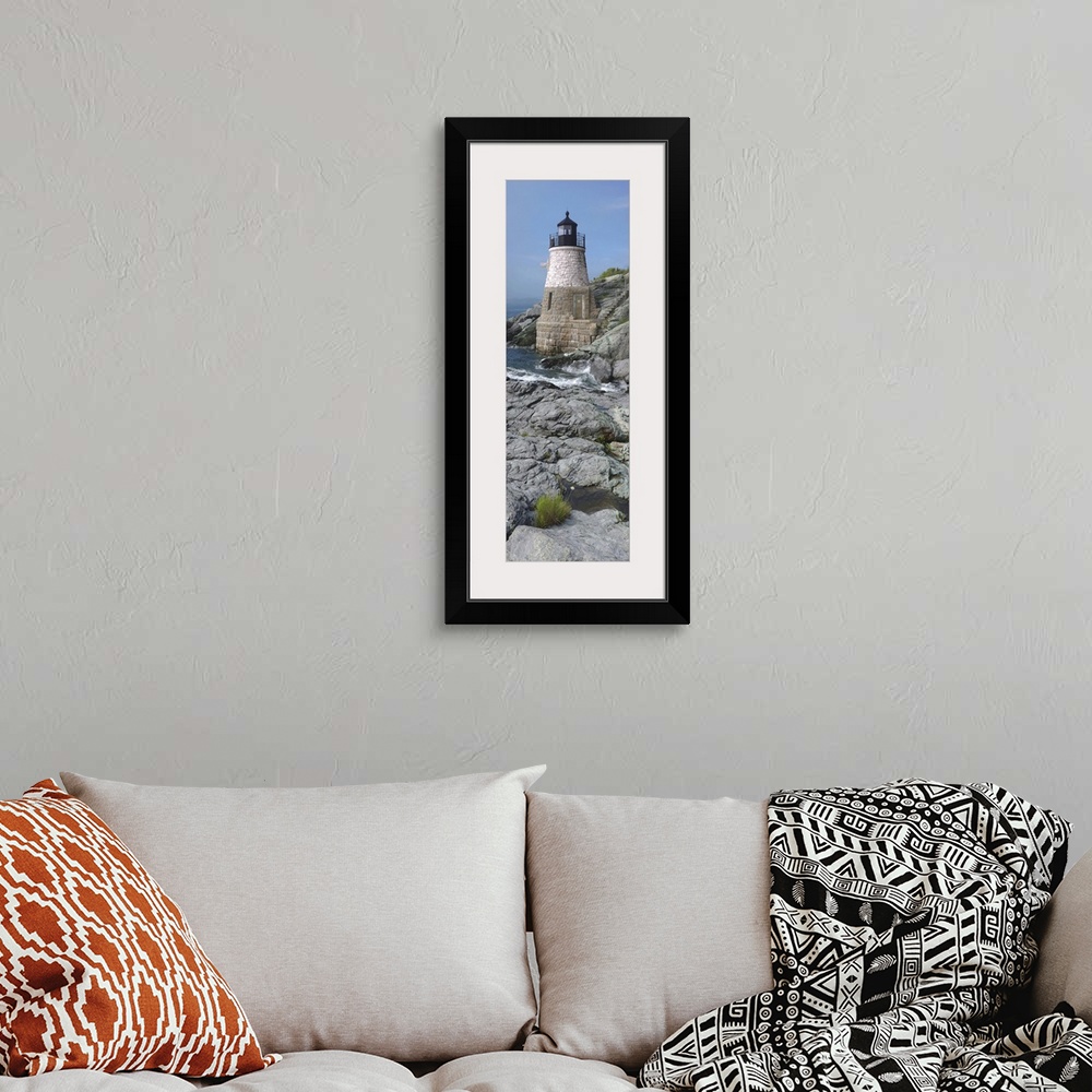 A bohemian room featuring This is a vertical photograph of light house on a rocky coast.
